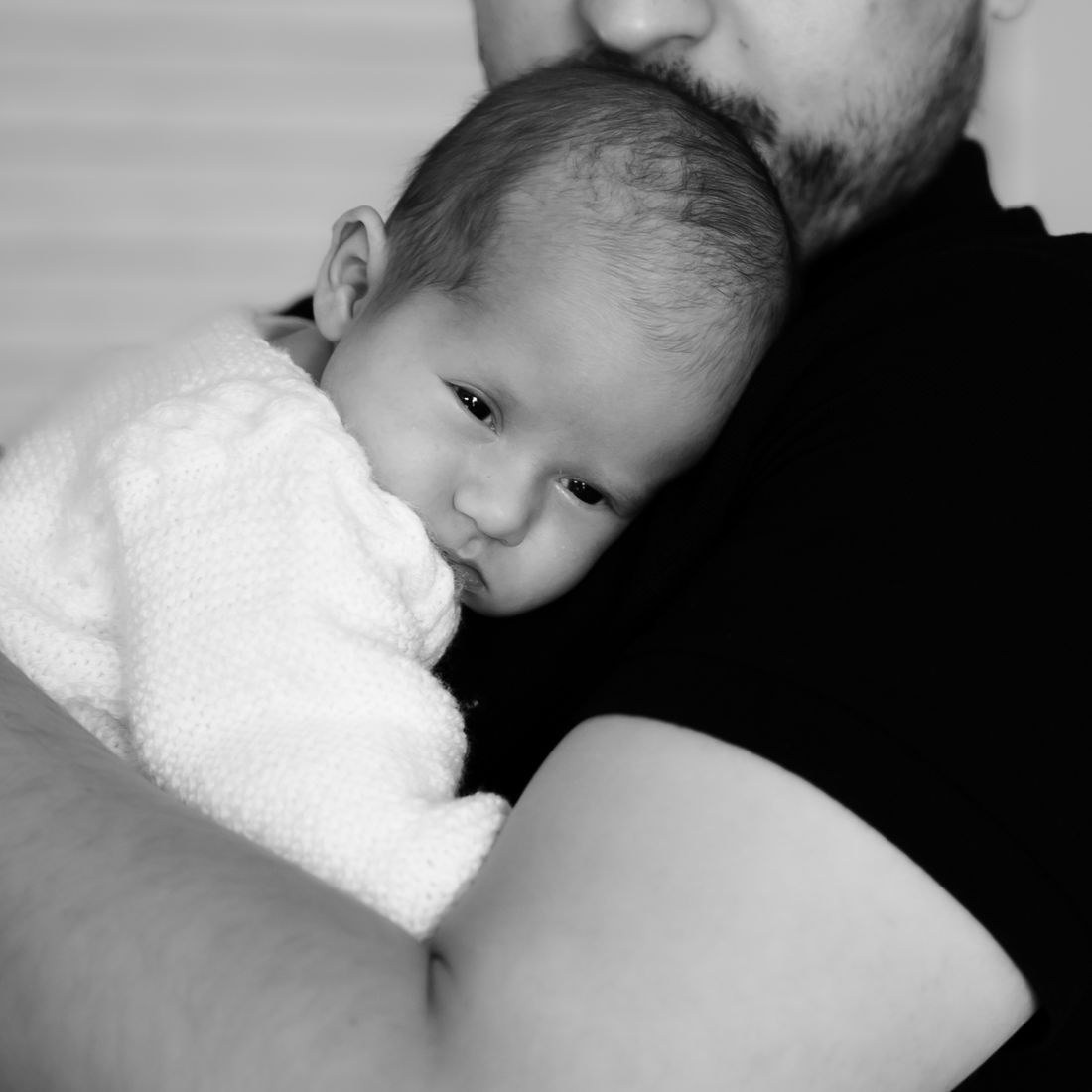 A father holding his baby close